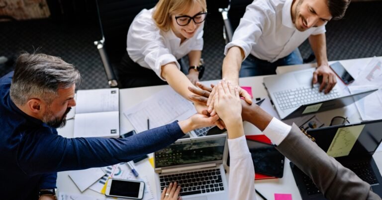 Officemates Stacking Hands Together