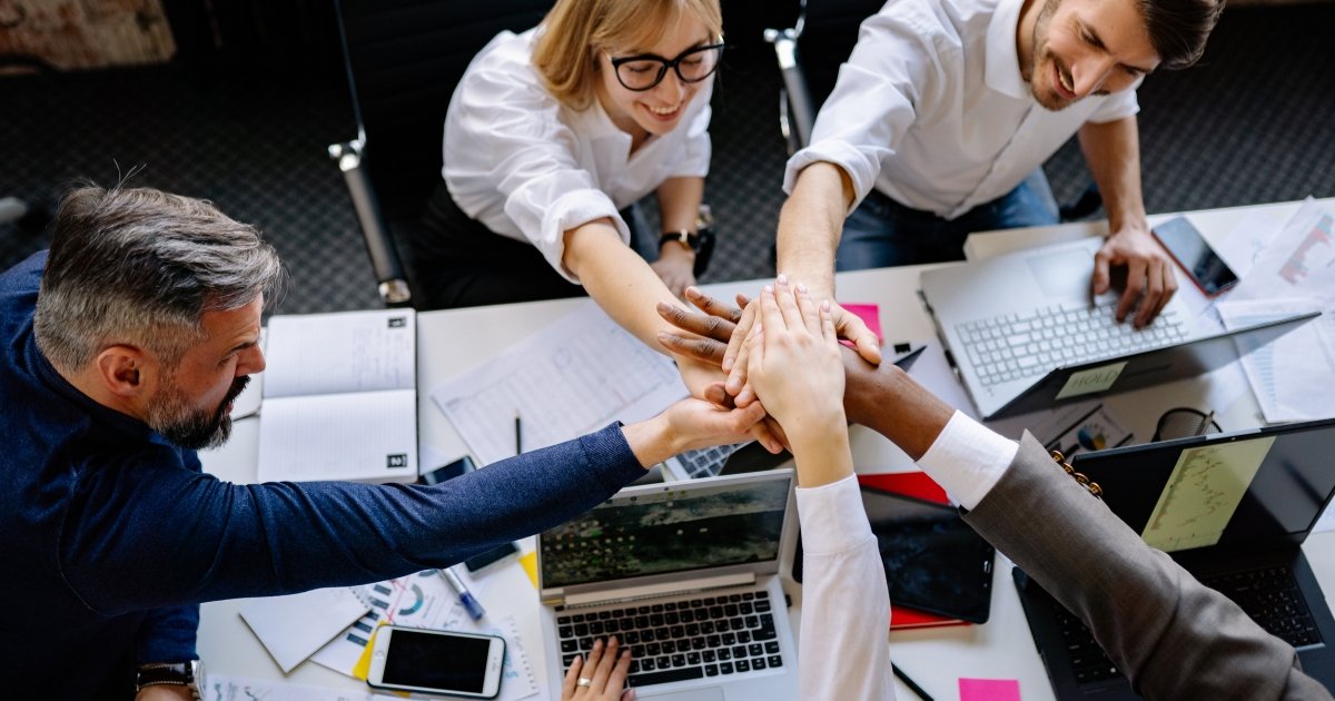 Officemates Stacking Hands Together